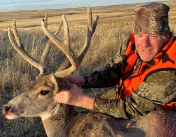 Mule Deer hunter with his deer still in velvet